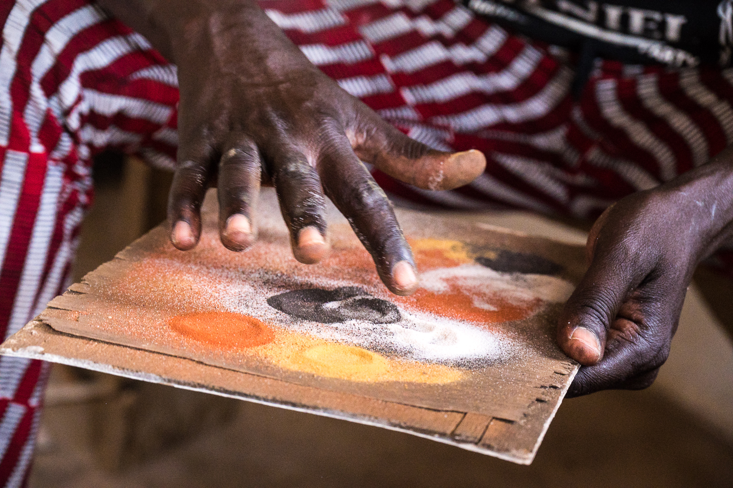 Peinture au sable dans le village de Mar Lodj